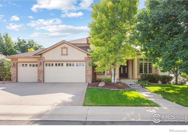 view of front of house with concrete driveway, a front lawn, an attached garage, and stucco siding