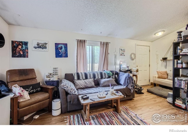 living room with hardwood / wood-style flooring and a textured ceiling