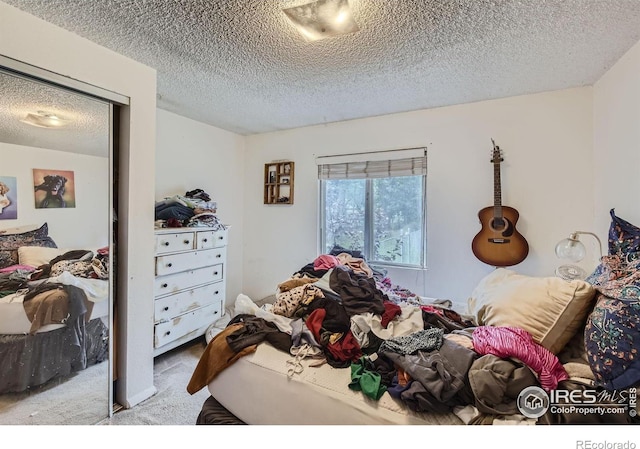 carpeted bedroom with a textured ceiling