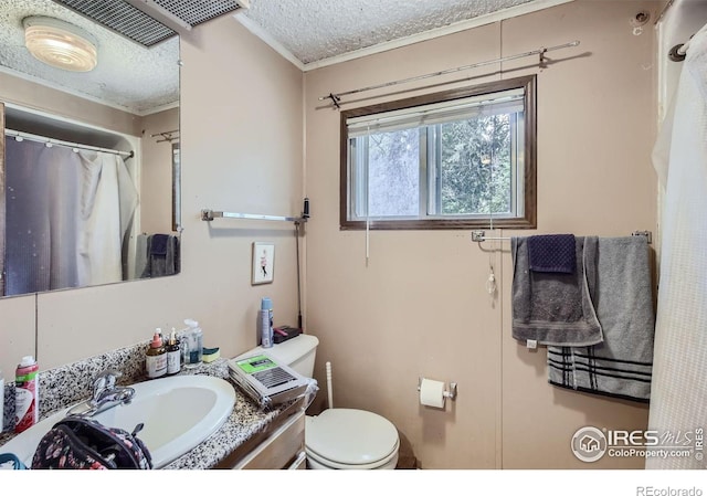 bathroom featuring a textured ceiling, toilet, and vanity