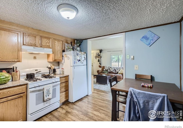 kitchen with white appliances, light hardwood / wood-style floors, and a textured ceiling