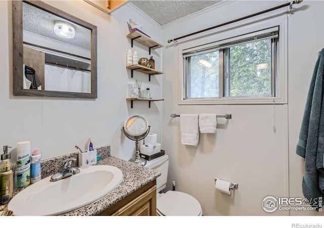 bathroom featuring a textured ceiling, toilet, vanity, and crown molding