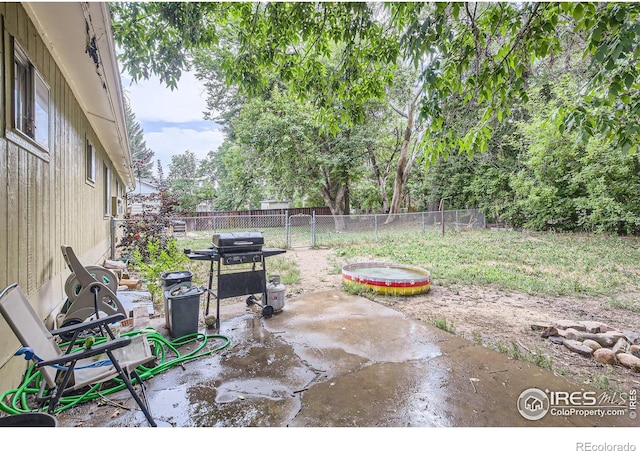 view of patio / terrace with a jacuzzi and area for grilling