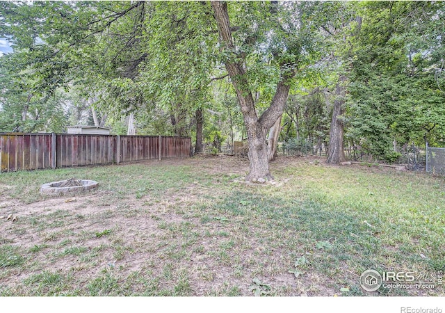 view of yard with a fire pit