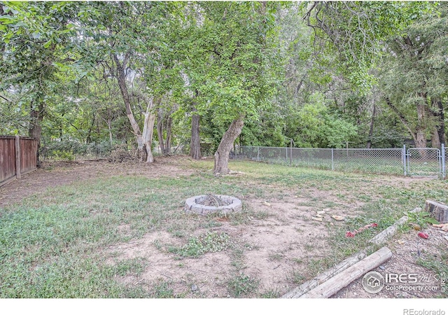 view of yard with an outdoor fire pit