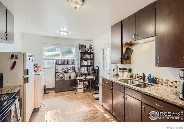 1308 Castlerock Dr, Fort Collins, CO 80521 - kitchen with dark brown cabinetry, light wood-type flooring, plenty of natural light, and sink