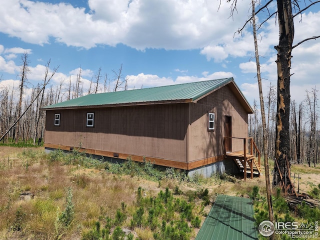 view of side of property with an outbuilding