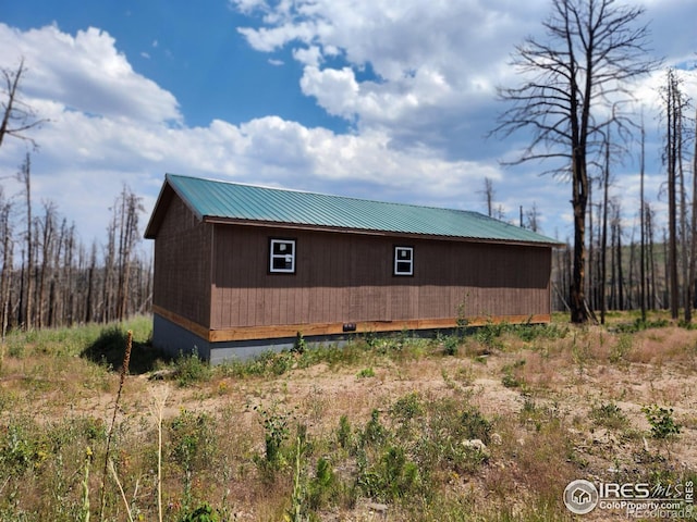 view of property exterior with an outbuilding