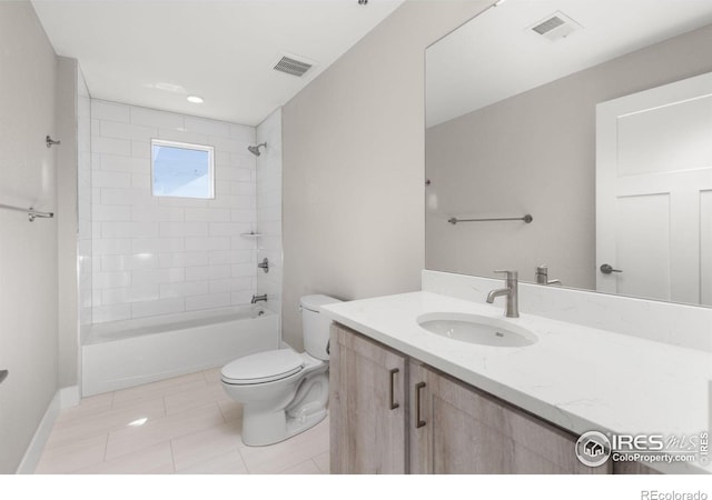 full bathroom featuring tile patterned floors, vanity, toilet, and tiled shower / bath