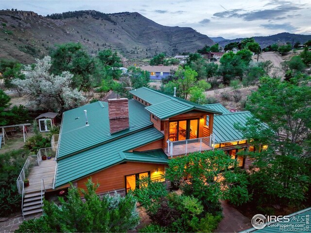 aerial view at dusk featuring a mountain view