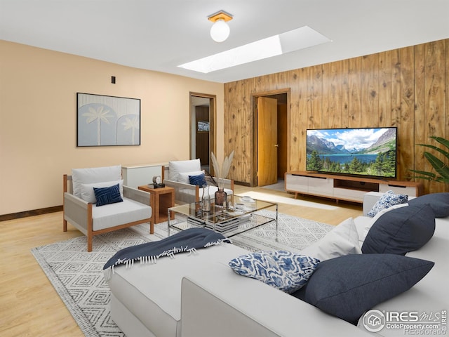 living area with a skylight, baseboards, wood finished floors, and wood walls