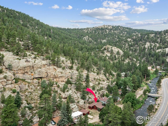 birds eye view of property with a wooded view