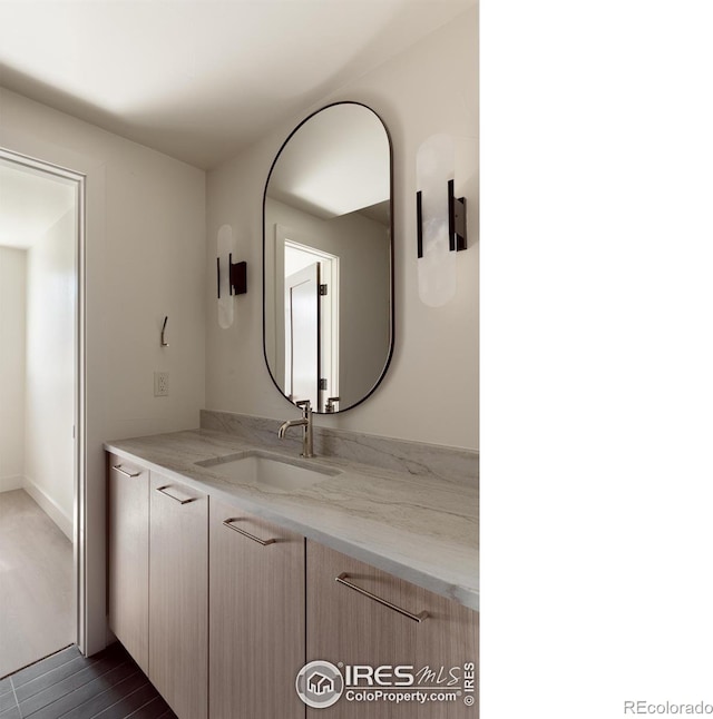 bathroom with vanity and hardwood / wood-style flooring