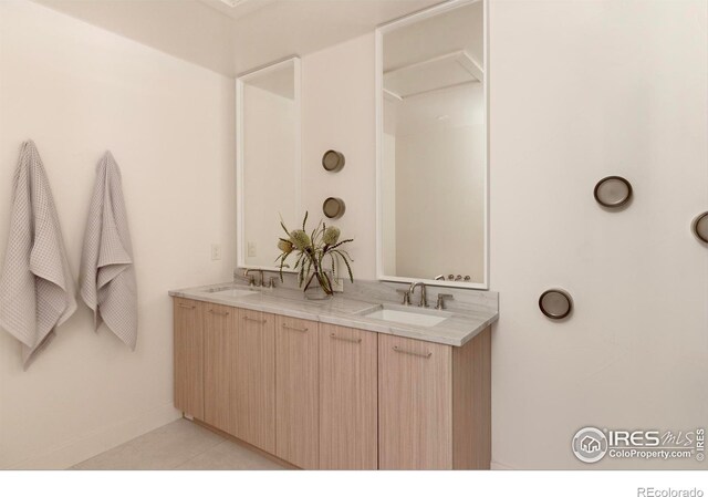 bathroom with tile patterned floors and vanity