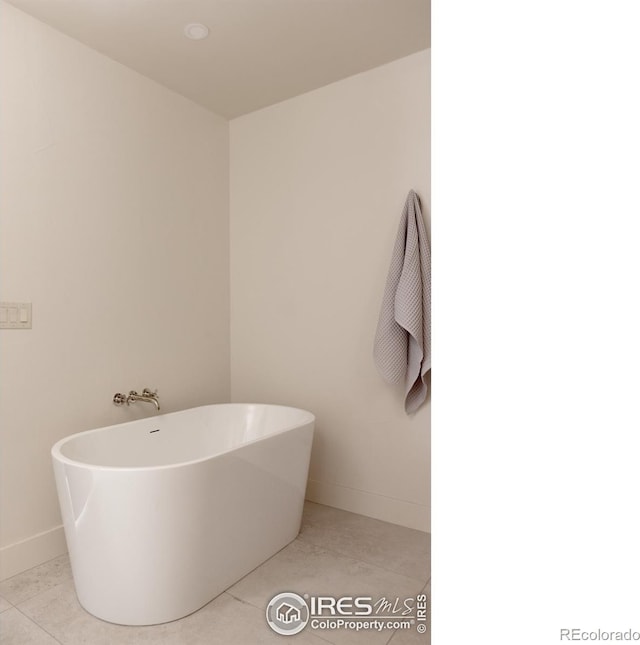 bathroom featuring tile patterned flooring and a bath