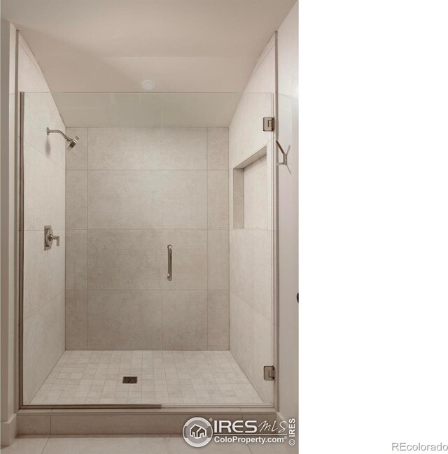 bathroom with a shower with door