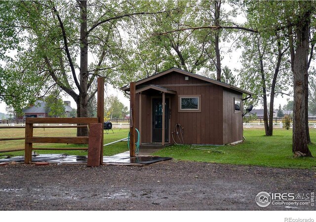 view of outdoor structure featuring a lawn