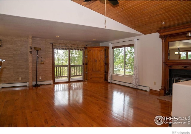 unfurnished living room featuring ceiling fan, hardwood / wood-style floors, brick wall, a baseboard radiator, and wooden ceiling