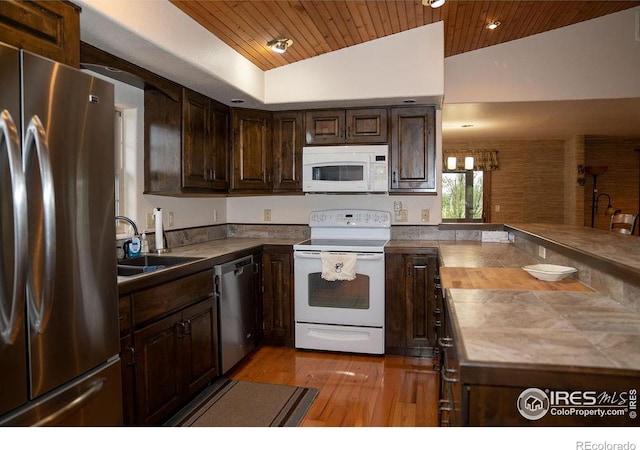 kitchen with sink, dark brown cabinets, stainless steel appliances, and wooden ceiling