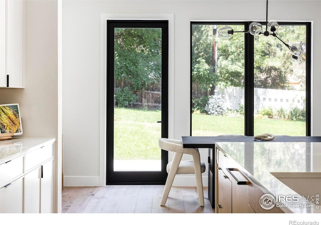 doorway to outside with light wood-type flooring