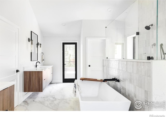 bathroom featuring lofted ceiling, vanity, and shower with separate bathtub