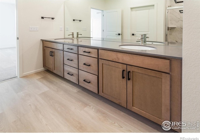 bathroom with vanity and hardwood / wood-style floors