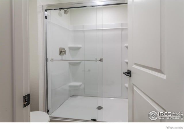 bathroom with a shower with shower door