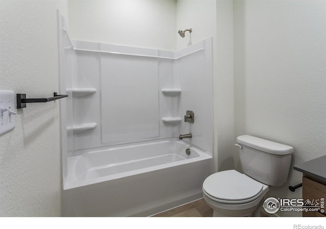 full bathroom with washtub / shower combination, vanity, and toilet