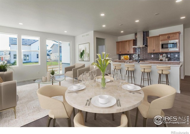 dining space with hardwood / wood-style flooring and sink