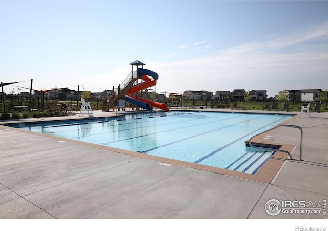 view of pool with a water slide