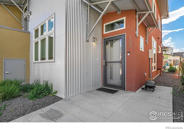 doorway to property with a patio