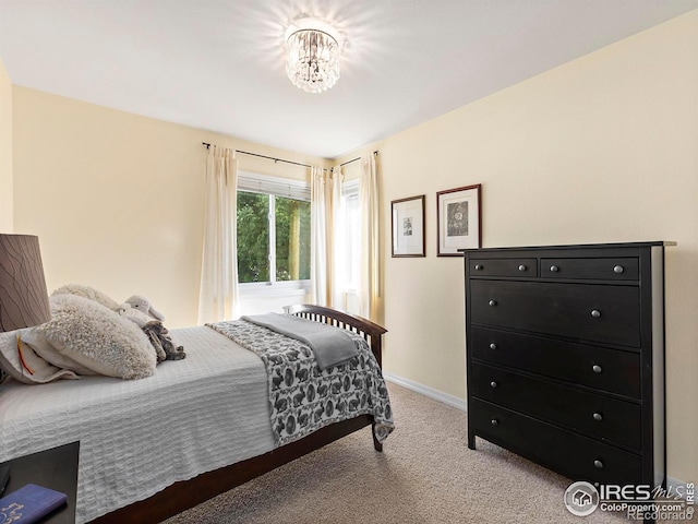 carpeted bedroom with a chandelier