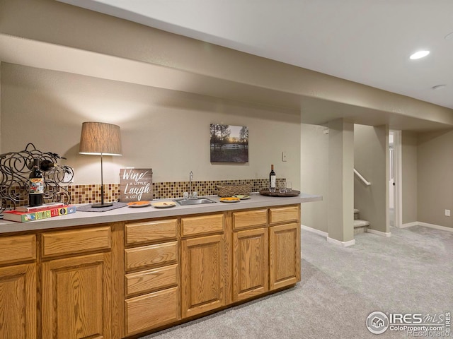 kitchen with sink, decorative backsplash, and light colored carpet