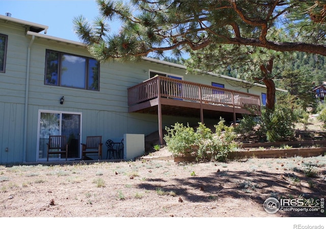 back of property featuring a wooden deck