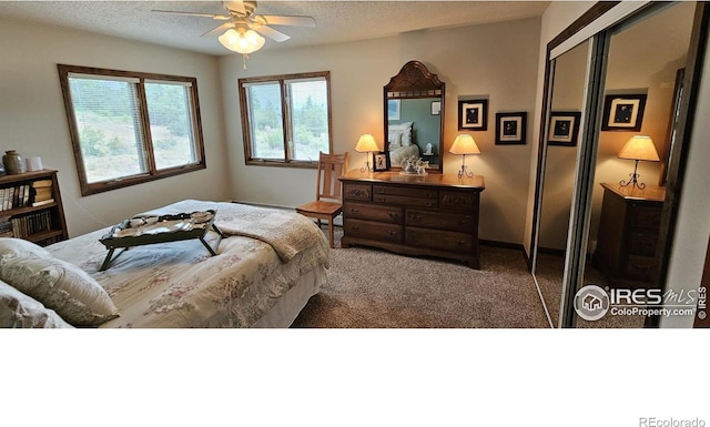 bedroom featuring a textured ceiling, ceiling fan, and carpet floors