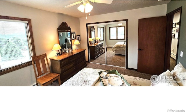 carpeted bedroom with a baseboard radiator, a closet, and ceiling fan