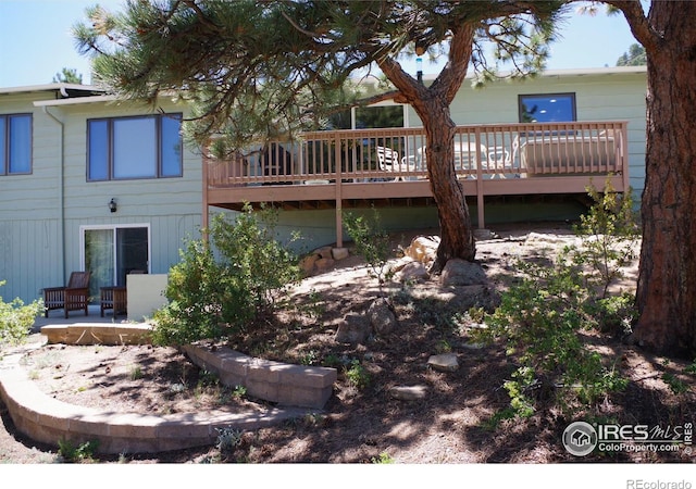 rear view of property featuring a deck