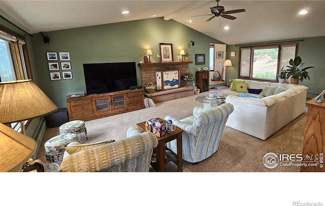 carpeted living room with vaulted ceiling with beams, a stone fireplace, and ceiling fan