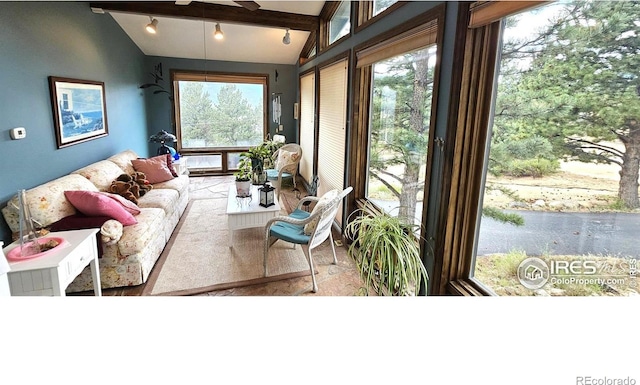 sunroom featuring vaulted ceiling with beams