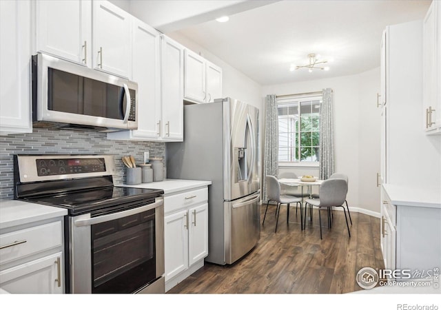 kitchen featuring stainless steel appliances, white cabinets, decorative backsplash, and dark hardwood / wood-style floors