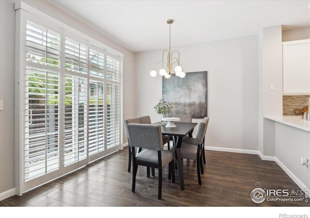 dining area featuring dark hardwood / wood-style flooring and a chandelier