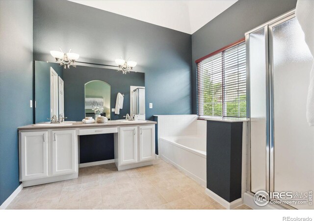 bathroom featuring independent shower and bath, vanity, tile patterned floors, and a chandelier