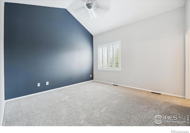 unfurnished room featuring ceiling fan, lofted ceiling, and carpet