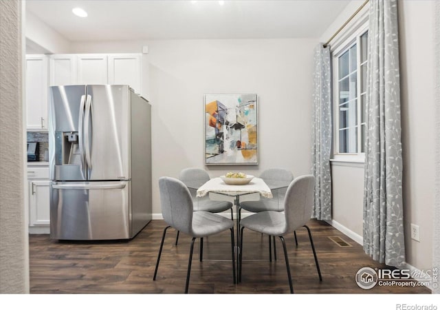 dining space with dark wood-type flooring