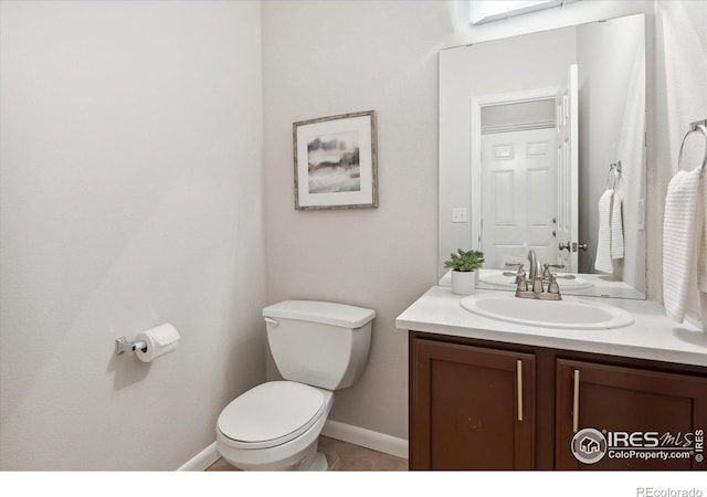 bathroom with toilet and vanity