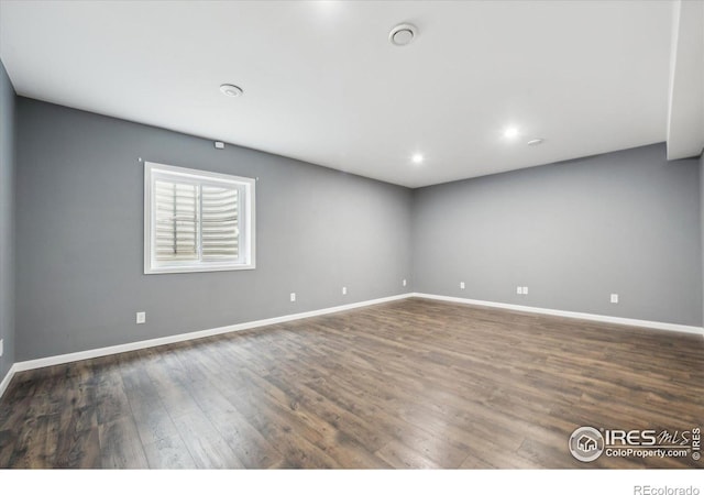 spare room featuring dark hardwood / wood-style flooring