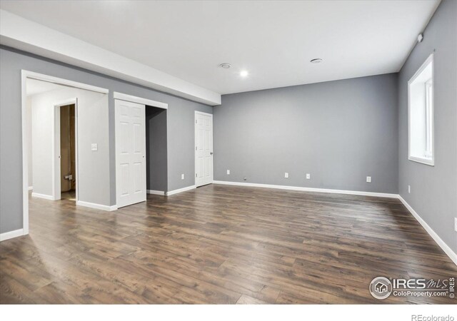 spare room with dark hardwood / wood-style flooring