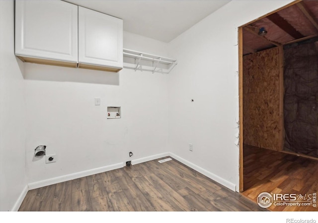 clothes washing area featuring dark hardwood / wood-style flooring, hookup for a washing machine, cabinets, and hookup for an electric dryer