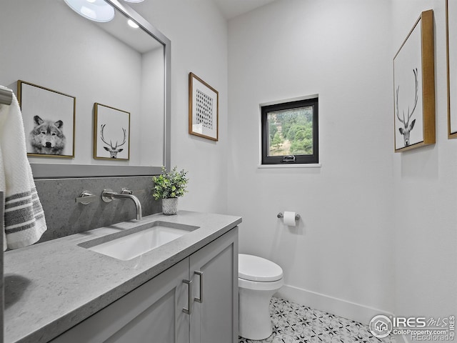 bathroom with vanity, tile patterned flooring, and toilet