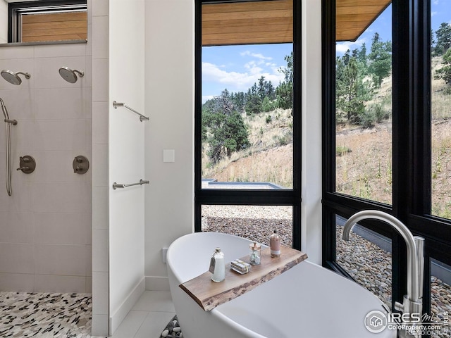 bathroom with plus walk in shower and tile patterned flooring